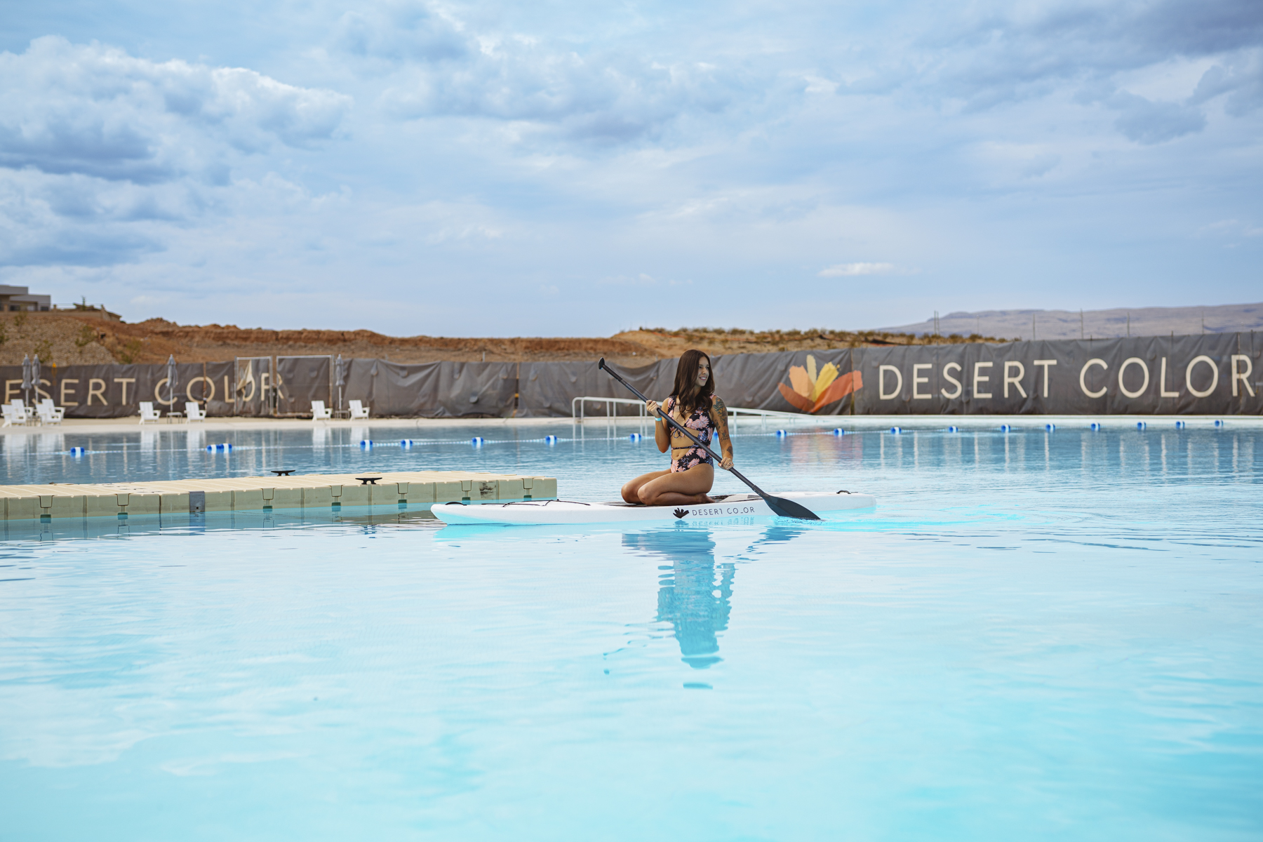Woman paddleboarding in the lagoon at Desert Color Resort, showcasing lifestyle branding, outdoor resort fun, and Utah vacation activities