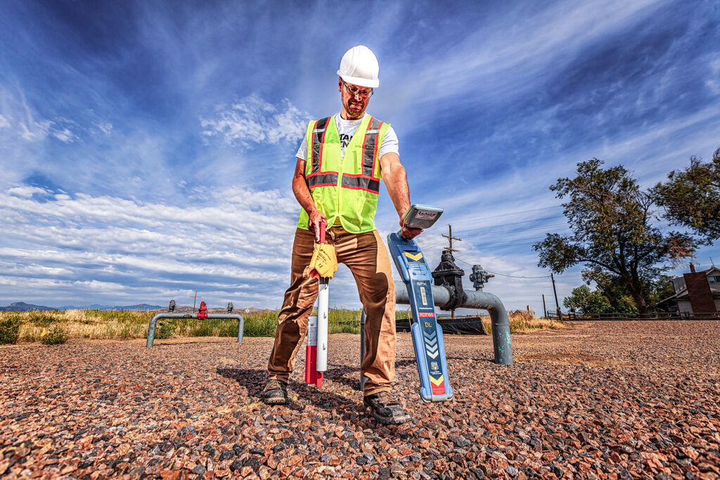 Utility locator uses precision equipment to detect underground gas lines near meter infrastructure during field operations for Stake Center Locating in Utah