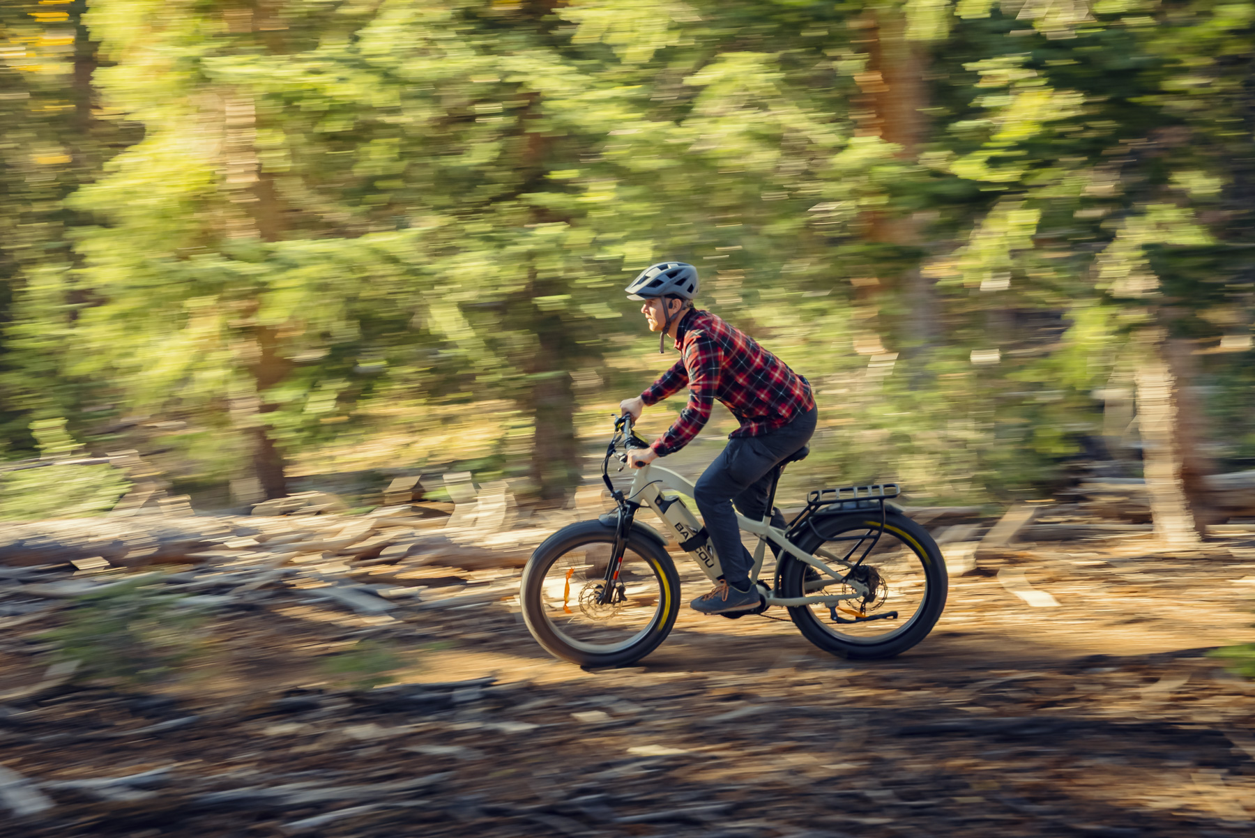 Professional mountain biking photography with motion blur showcasing electric bike performance on forest trails