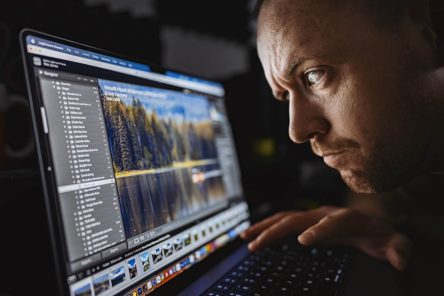 Utah photographer intensely editing landscape photo in Lightroom Classic, focused on color and detail during post-processing session
