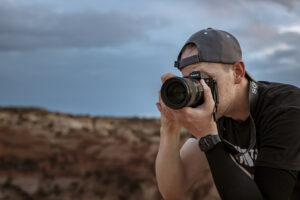 Utah photographer capturing sunset landscape in Moab using Sony Alpha camera during lifestyle content shoot in desert terrain