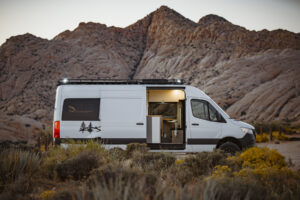 Camper van parked at golden hour in Snow Canyon Utah, highlighting vanlife freedom and desert road trip lifestyle