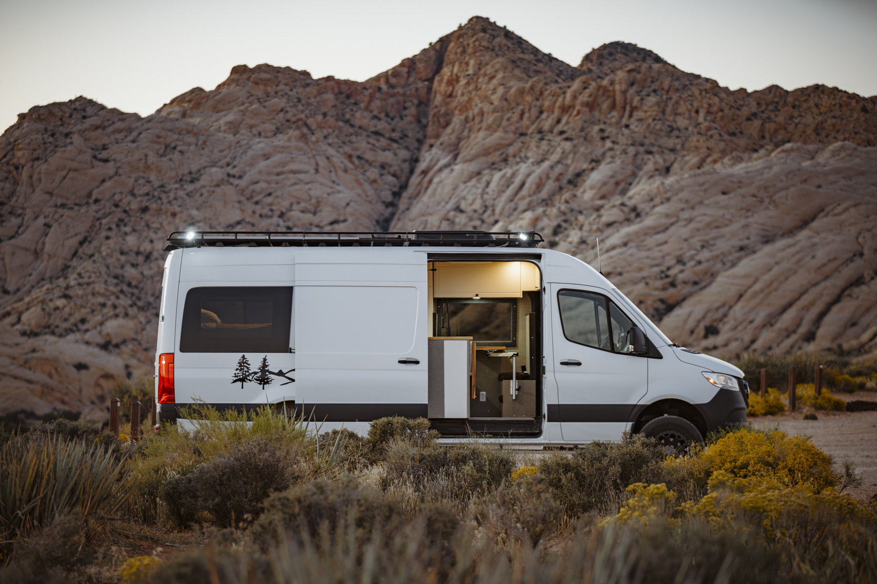 Camper van parked at golden hour in Snow Canyon Utah, highlighting vanlife freedom and desert road trip lifestyle