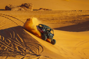 UTV climbs a sharp dune at Sand Hollow State Park on a Southern Utah Adventure Center off-road tour experience